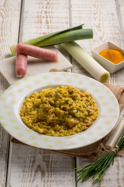 Risotto with sausage leek turmeric and chive — Stock Photo, Image