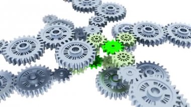 Beyaz bir arka plan ile bazı küçük yeşil dişli sonsuz dönüş odaklı gümüş vites