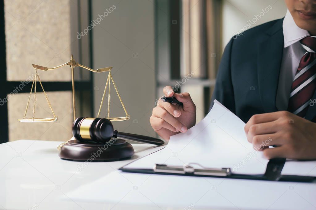 Justice and law concept.Male lawyer in the office with brass scale.