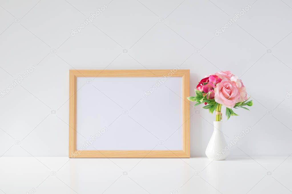 Mock up horizontal photo frame with flowers on table, home decoration.