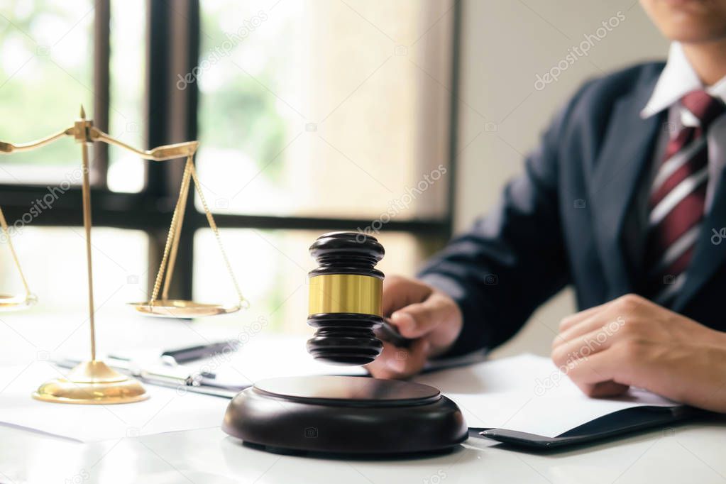 Justice and lawfirm concept.Male lawyer in the office with brass scale