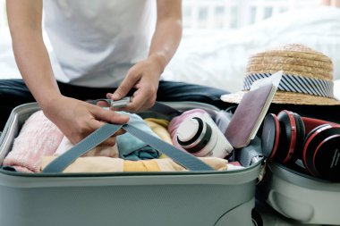 Tatil veya seyahat için hazırlık. Büyük açık bavul onun giyim ve malzeme neredeyse zaten tam ambalaj.