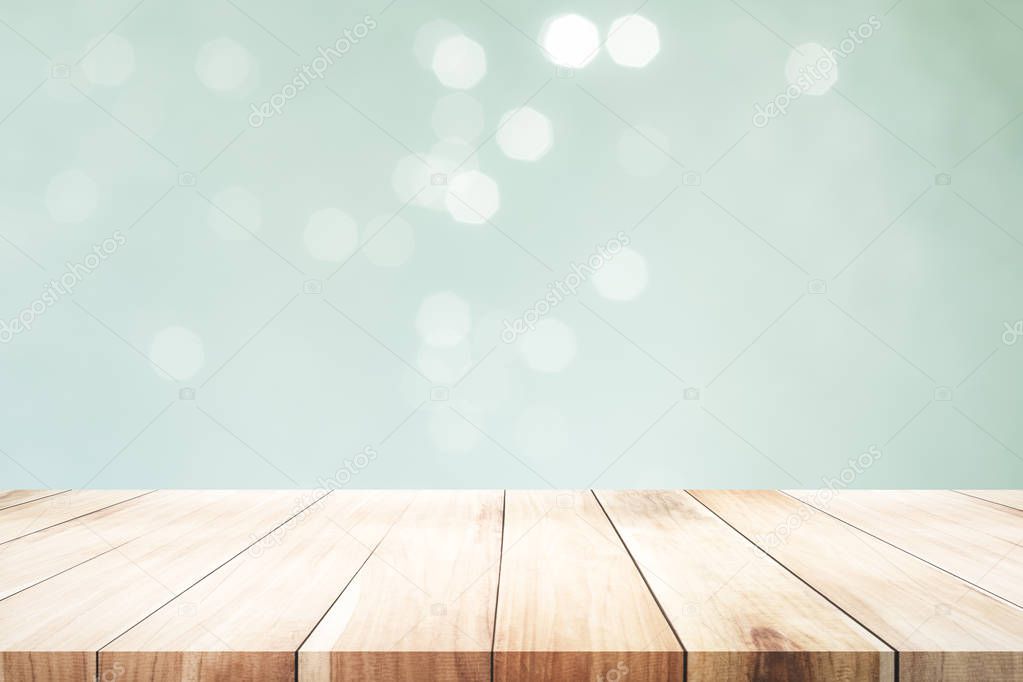 Wood table top on mint  bokeh abstract background and used for montage or display products.