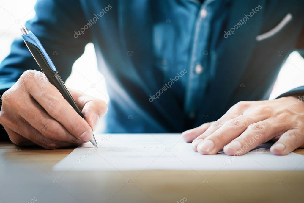 Close up businessman signing contract making a deal.