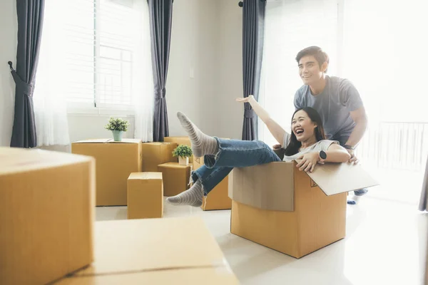 Happy young couple enjoying together moving in a new house.