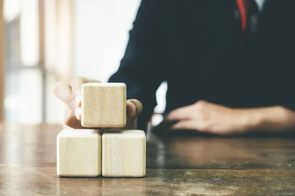 Businessman hand arranging wood block business strategy. — Stock Photo, Image