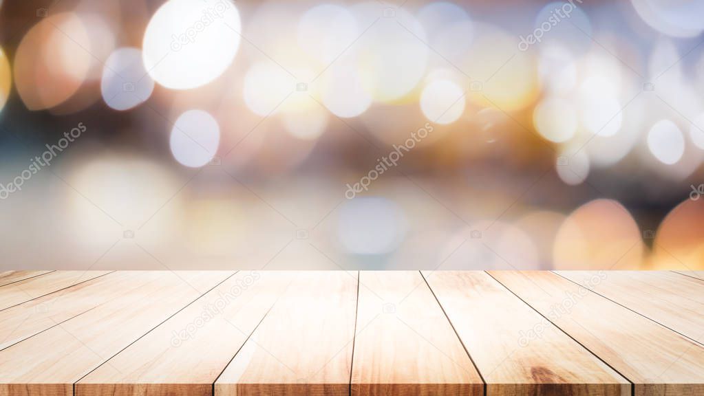 Wood table top on bokeh abstract background and used for montage