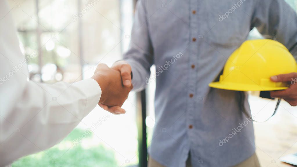 Two civil engineer or architect handshaking have deal mega proje