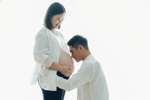 Pregnant woman with husband. Family, pregnancy and parenthood concept.