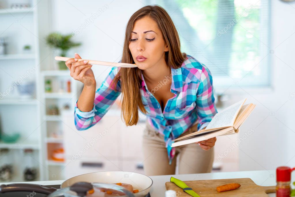 young woman making healthy meal in domestic kitchen