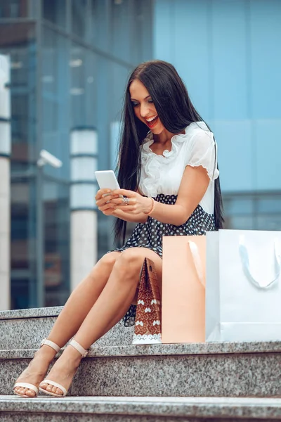 Młoda Kobieta Torby Zakupy Przy Użyciu Smartfona Zakupy — Zdjęcie stockowe