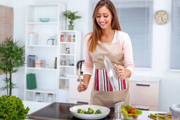 若い女性が台所で健全なブロッコリーを調理 — ストック写真