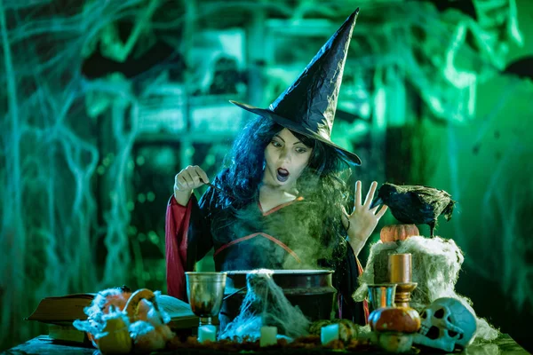 年轻的女巫与可怕的脸阅读食谱的神奇饮料在恐怖的环境和烟雾背景 — 图库照片