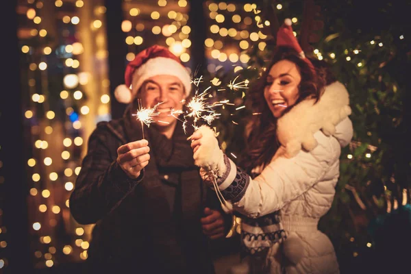 Cute Cheerful Couple Sparklers Enjoying Christmas Eve City Street Lot — Stock Photo, Image