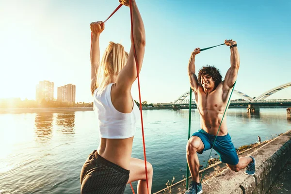 Young Fitness Couple Doing Workout Rubber Band River Sunset — Stock Photo, Image