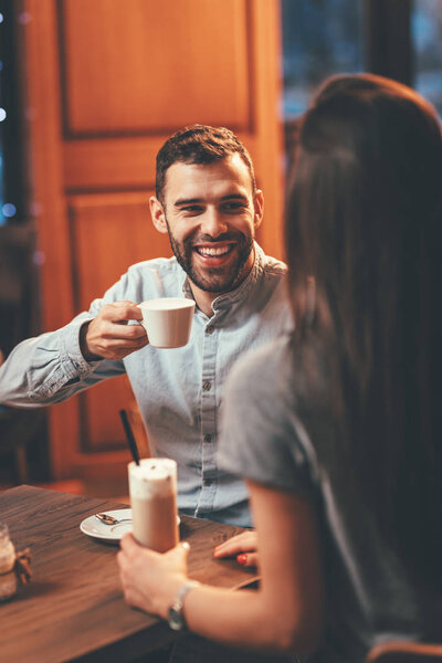Romantic loving couple drinking coffee having date in cafe