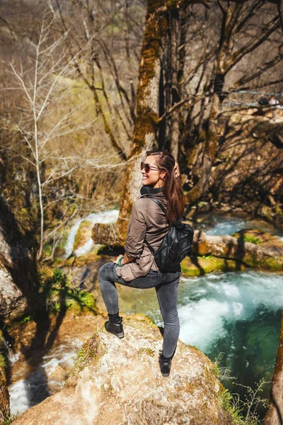 happy woman enjoying landscape in mountain creek