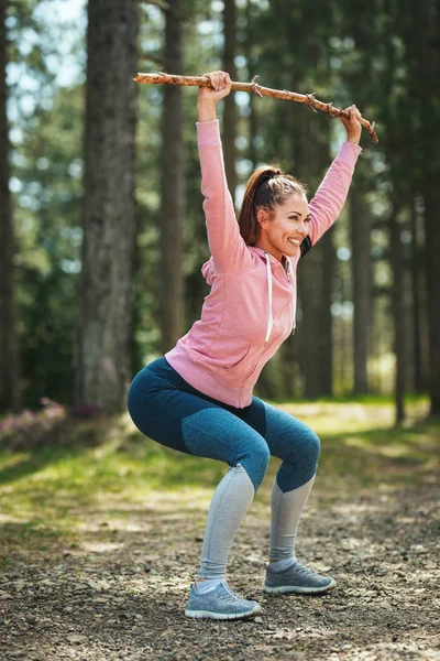 Lycklig Kvinna Snygg Sportkläder Stretching Sunny Forest — Stockfoto