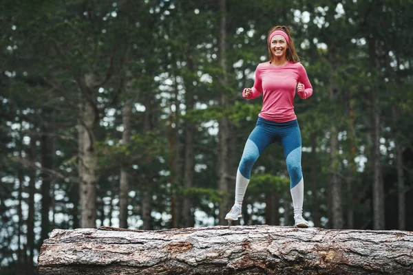 Young Cheerful Female Runner Training Old Tree Trunk Forest — 스톡 사진