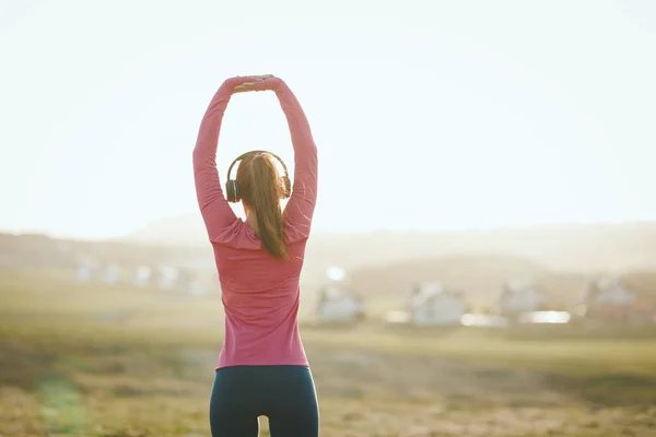 Young Female Runner Listening Music Stretching Jogging Sunset Mountains — Stock Photo, Image