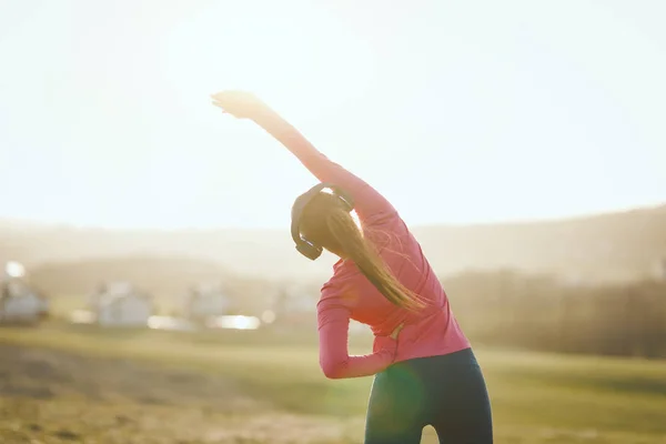 Young Female Runner Listening Music Stretching Jogging Sunset Mountains — 스톡 사진