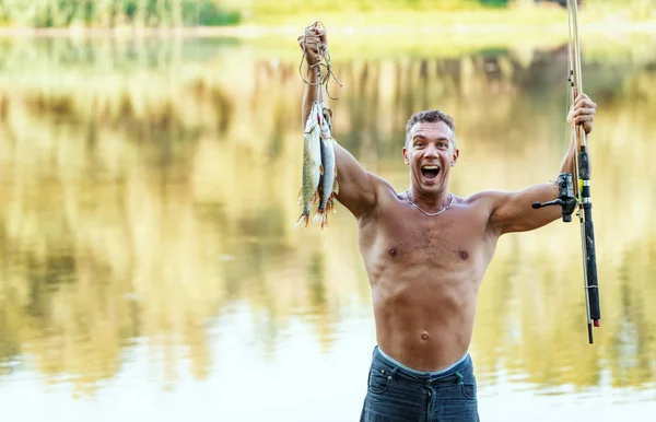 Young Handsome Satisfied Happy Fisherman Holding Caught Fishes Hook — Stockfoto