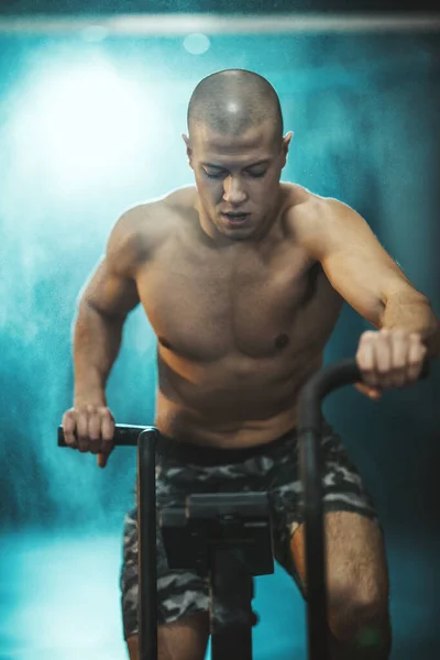 Joven Musculoso Está Haciendo Entrenamiento Duro Crossfit Bicicleta Gimnasio —  Fotos de Stock