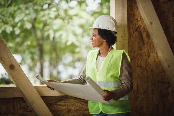 Shot African Female Architect Checking Plans Construction Site New Wooden — Stock Photo, Image