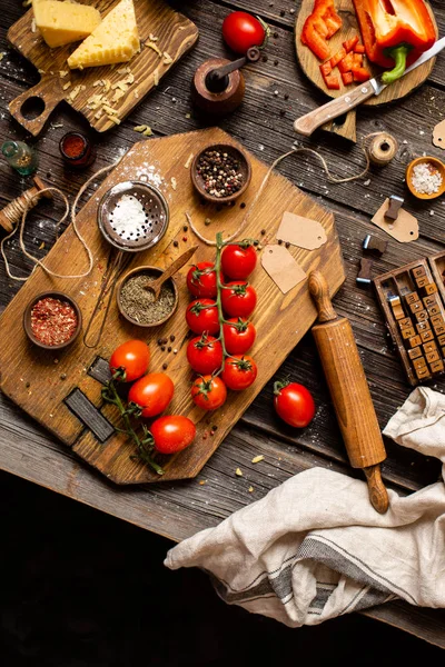 Overhead shot of branch ripe cherry tomatoes on wooden board
