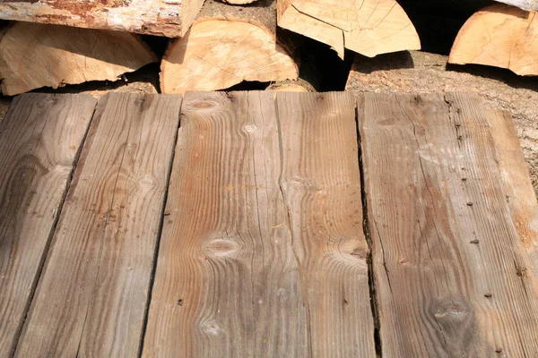 Leerer Holzdecktisch Mit Haufen Brennholz Hintergrund — Stockfoto