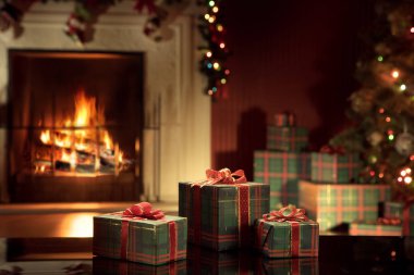 Arkadaki sarılmış hediyeler ve şömine ile Noel ağacı görüntüle