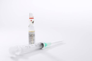Close up view of the ampule with medicine and syringe on white back  clipart