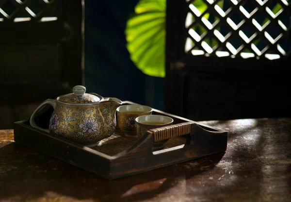 Close up view of nice china teapot and glasses on color back