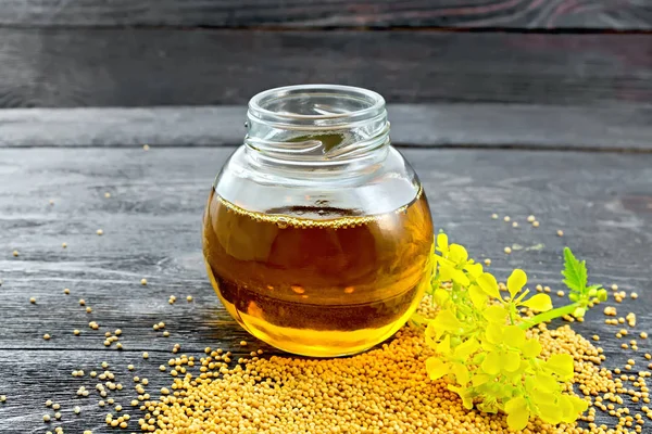 Mustard Oil Glass Jar Flower Seeds Wooden Board Background — Stock Photo, Image