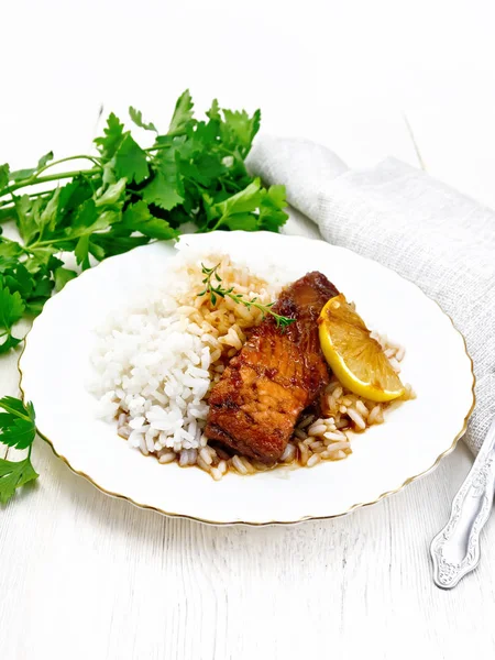 Salmon with sauce and rice in plate on board — Stock Photo, Image