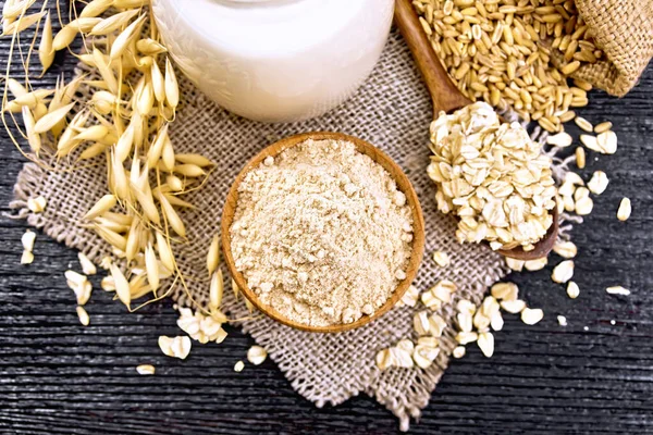 Flour oat in bowl on dark board top — Stock Photo, Image