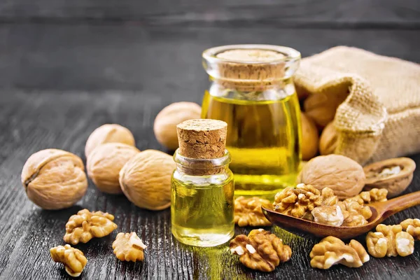 Walnut Oil Glass Bottle Jar Nuts Bag Spoon Table Dark — Stock Photo, Image