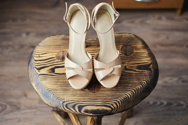 Wooden chair on it pink high-heeled sandals gently pink