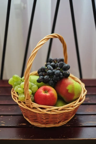 Baskets of apples and red and green grapes. Fruit baskets.