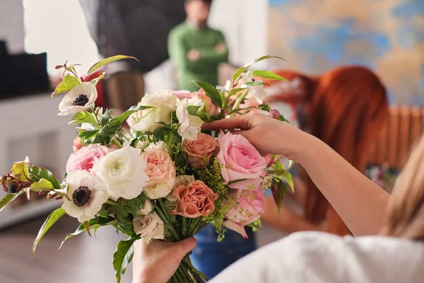 hands of florist collect wedding bouquet. florist at work