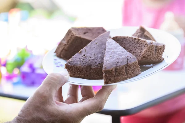 Male Hand Giving Plate Chocolate Cake — Stock Photo, Image