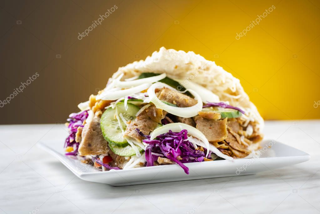 Kebab - pieces of roasted meat with a mixture of vegetables in crispy bread