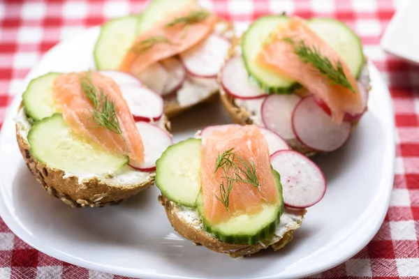 tasty breakfast - small sandwiches with salmon on vegetables