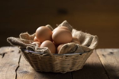 Tarım turizminde tahta bir masada sepetteki yumurtalar.