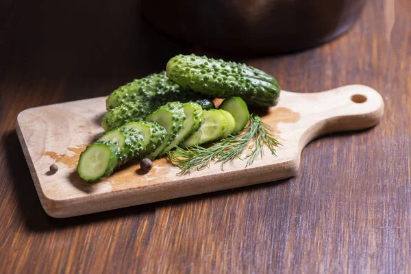 Pickled cucumbers in a stone pot — Stock Photo, Image