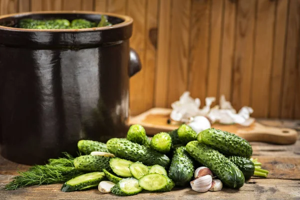 Pickled cucumbers in a stone pot — Stock Photo, Image