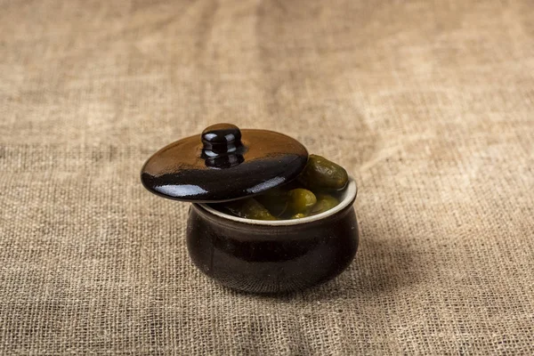 Pickled cucumbers in a small stone pot — Stock Photo, Image