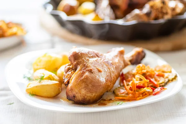 baked turkey leg with potatoes and vegetable salad