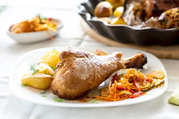 baked turkey leg with potatoes and vegetable salad