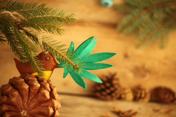 handmade toy cannabis leaf in the bird's beak. Cannabis marijuana new year product recreation